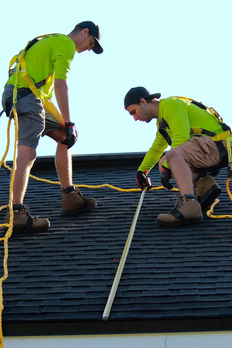 Men in safety gear on roof