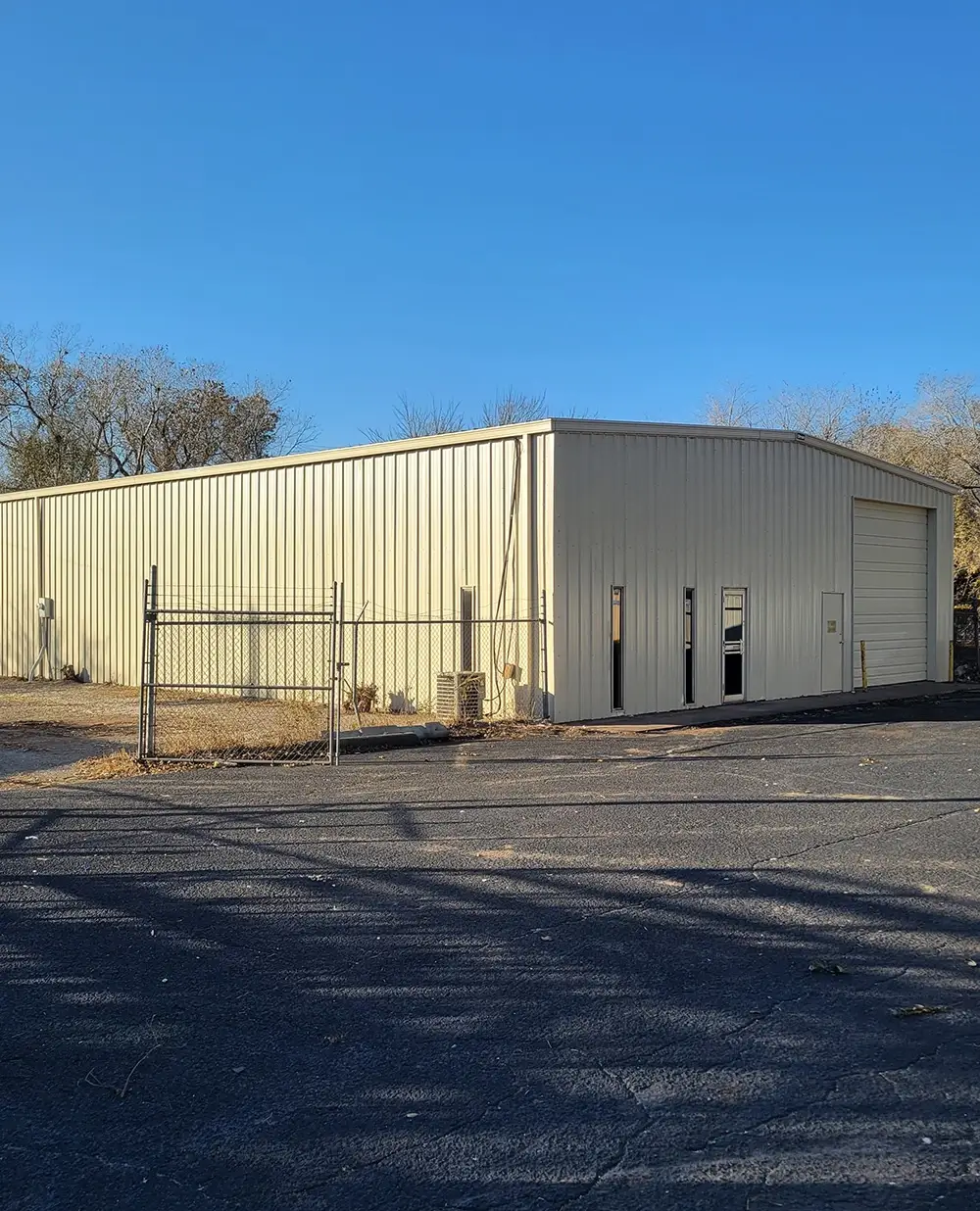 A shop building with replaced metal panels and new gutters
